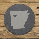 Arkansas round slate coaster engraved with the state shape and a star