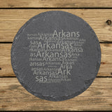 Arkansas round slate coaster engraved with a word cloud of repeating Arkansas text
