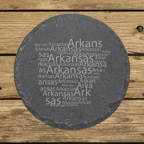 Arkansas round slate coaster engraved with a word cloud of repeating Arkansas text