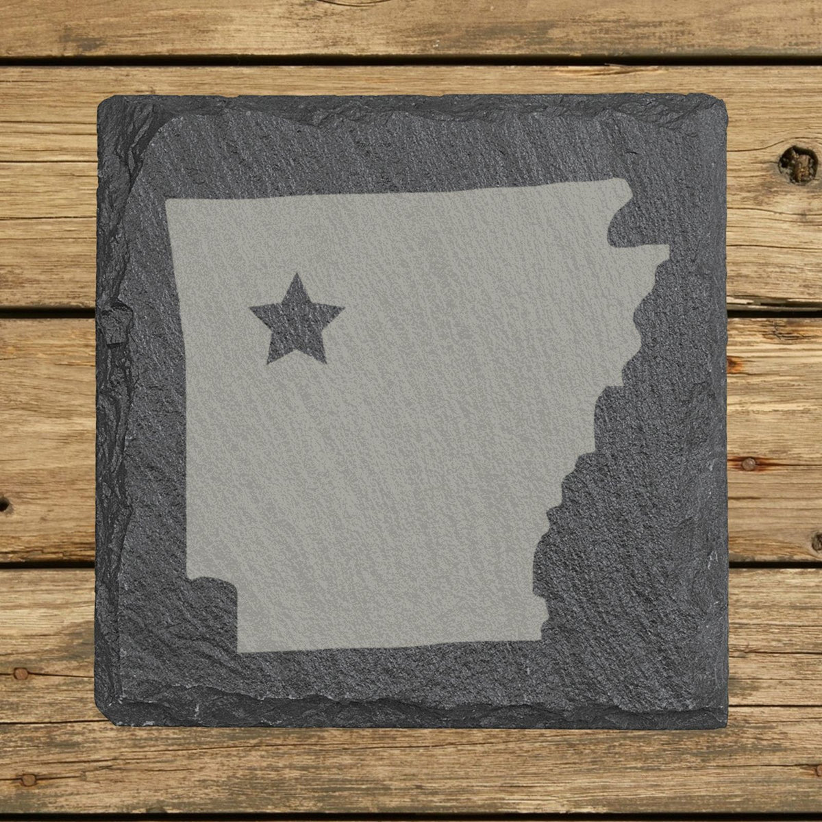 Arkansas square slate coaster engraved with the state shape and a star
