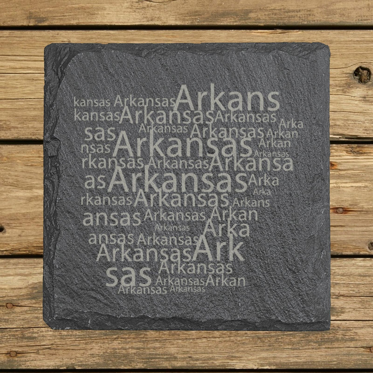 Arkansas square slate coaster engraved with a word cloud of repeating Arkansas text