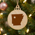 Arkansas round wood Christmas ornament engraved with the state shape and a star