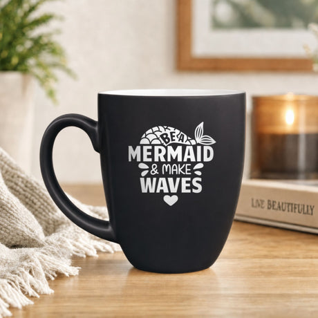 Black 16 oz ceramic coffee mug with "Be a Mermaid and Make Waves", mermaid scales design