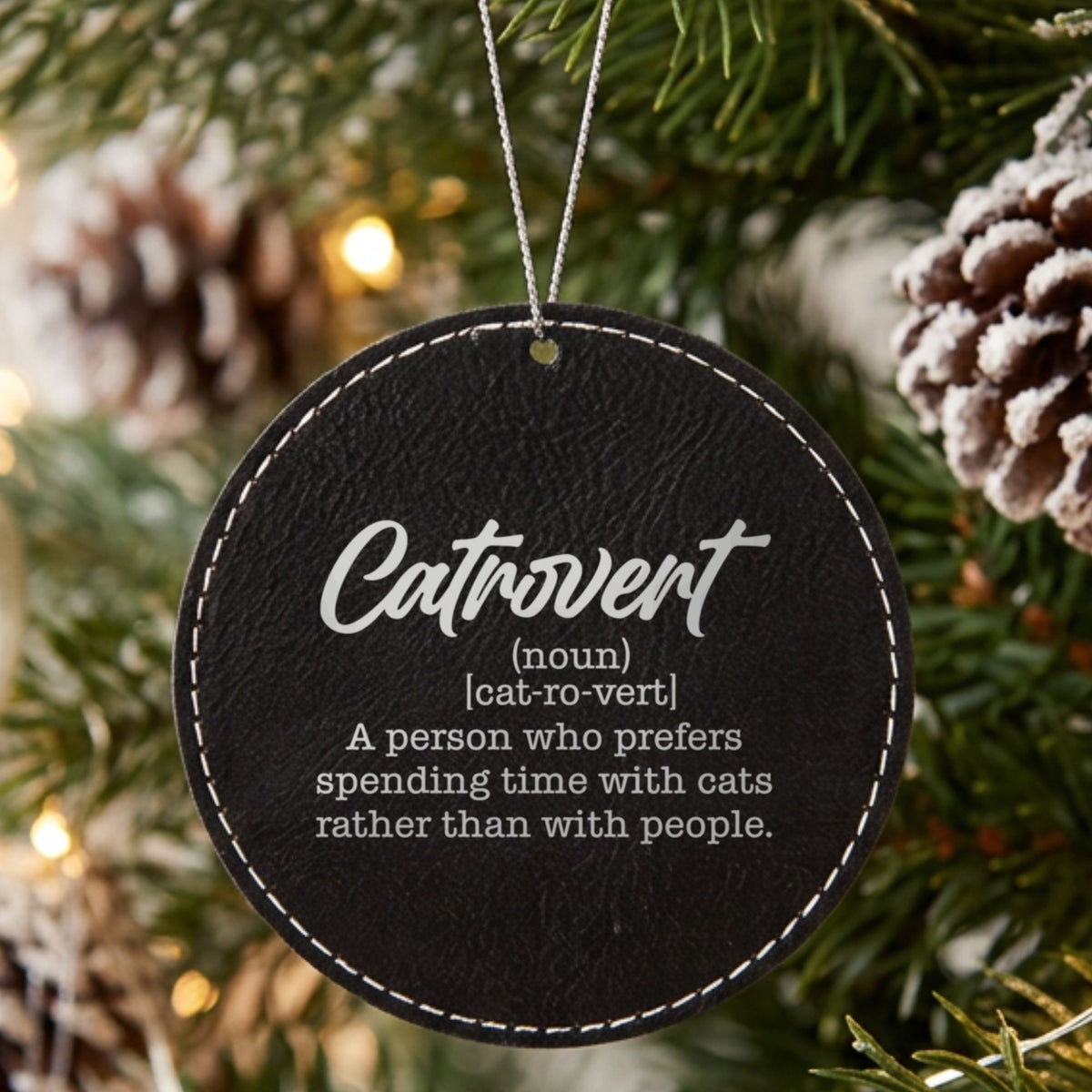 Black leatherette Christmas ornament engraved with the Catrovert definition