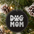 Black leatherette Christmas ornament engraved with a retro bubble letter Dog Mom design with a paw print