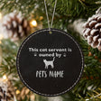 Black leatherette Christmas ornament engraved with the This Cat Servant is Owned By design