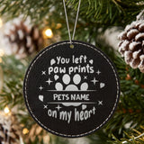 Black leatherette Christmas ornament engraved with the You Left Paw Prints on My Heart design