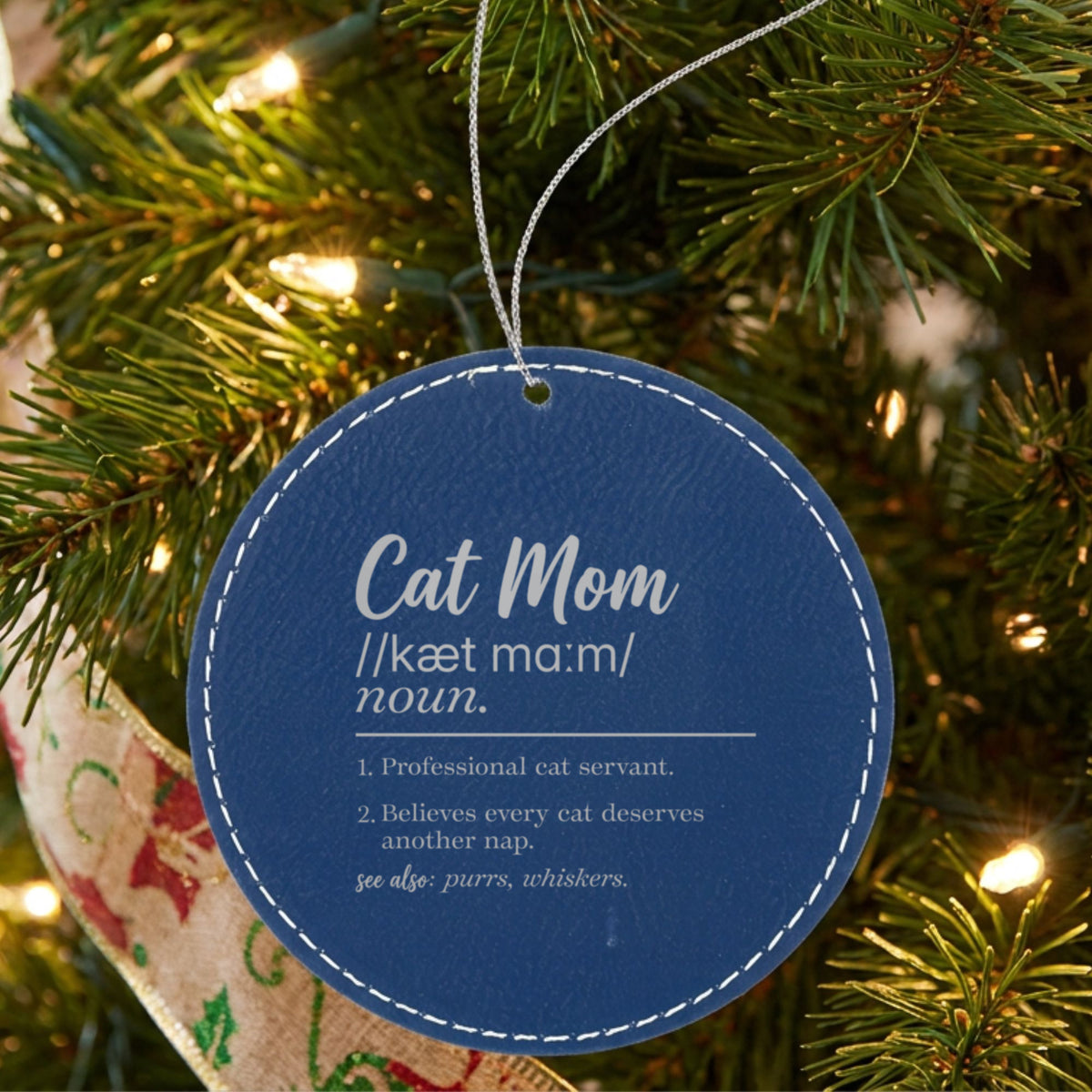 Blue leatherette Christmas ornament engraved with the Cat Mom definition