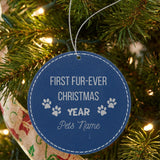 Blue leatherette Christmas ornament engraved with the First Fur-Ever Christmas paw print design