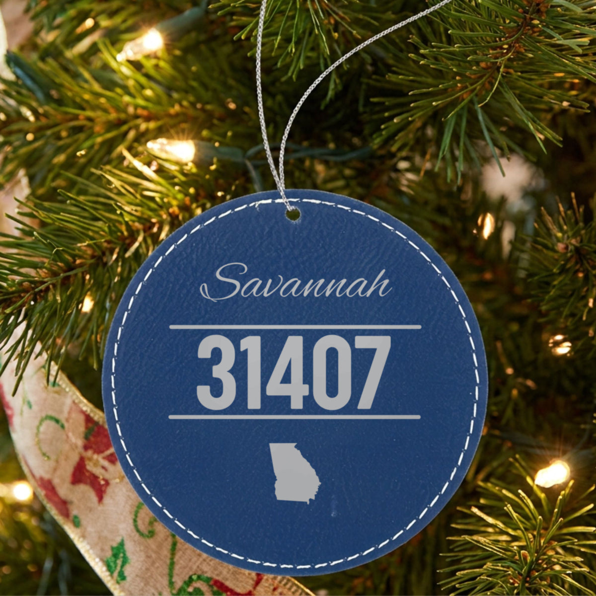 Blue leatherette Christmas ornament laser engraved with the City and State Outline zip code design