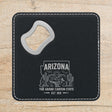 Black leatherette bottle opener coaster laser engraved with an Arizona design of saguaro cactus, a roadrunner and the Grand Canyon at sunrise
