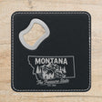 Black leatherette bottle opener coaster laser engraved with a Montana design of a grizzly bear, a trout and mountain peaks