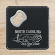 Black leatherette bottle opener coaster laser engraved with a North Carolina design of a lighthouse, the Blue Ridge and dogwood blossoms