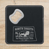 Black leatherette bottle opener coaster laser engraved with a North Dakota design of a bison on the plains