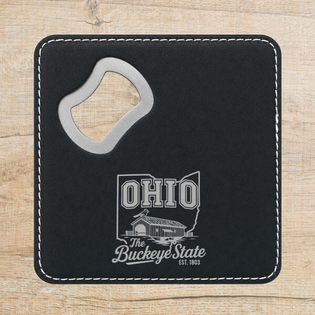 Black leatherette bottle opener coaster laser engraved with an Ohio design of a covered bridge and a cardinal