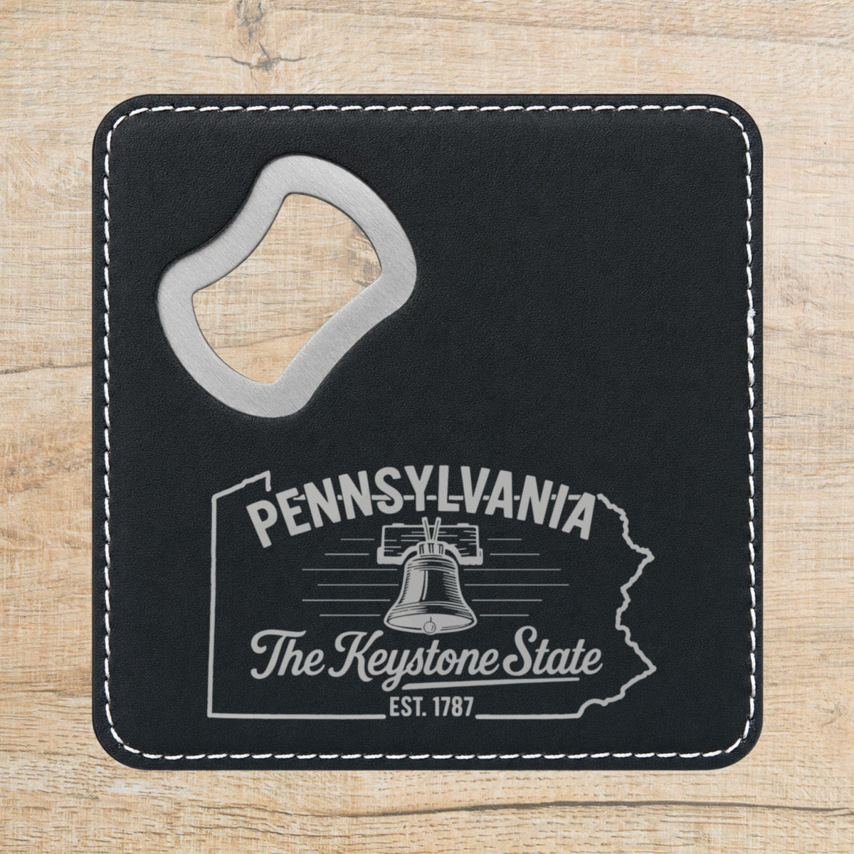 Black leatherette bottle opener coaster laser engraved with a Pennsylvania design of the Liberty Bell