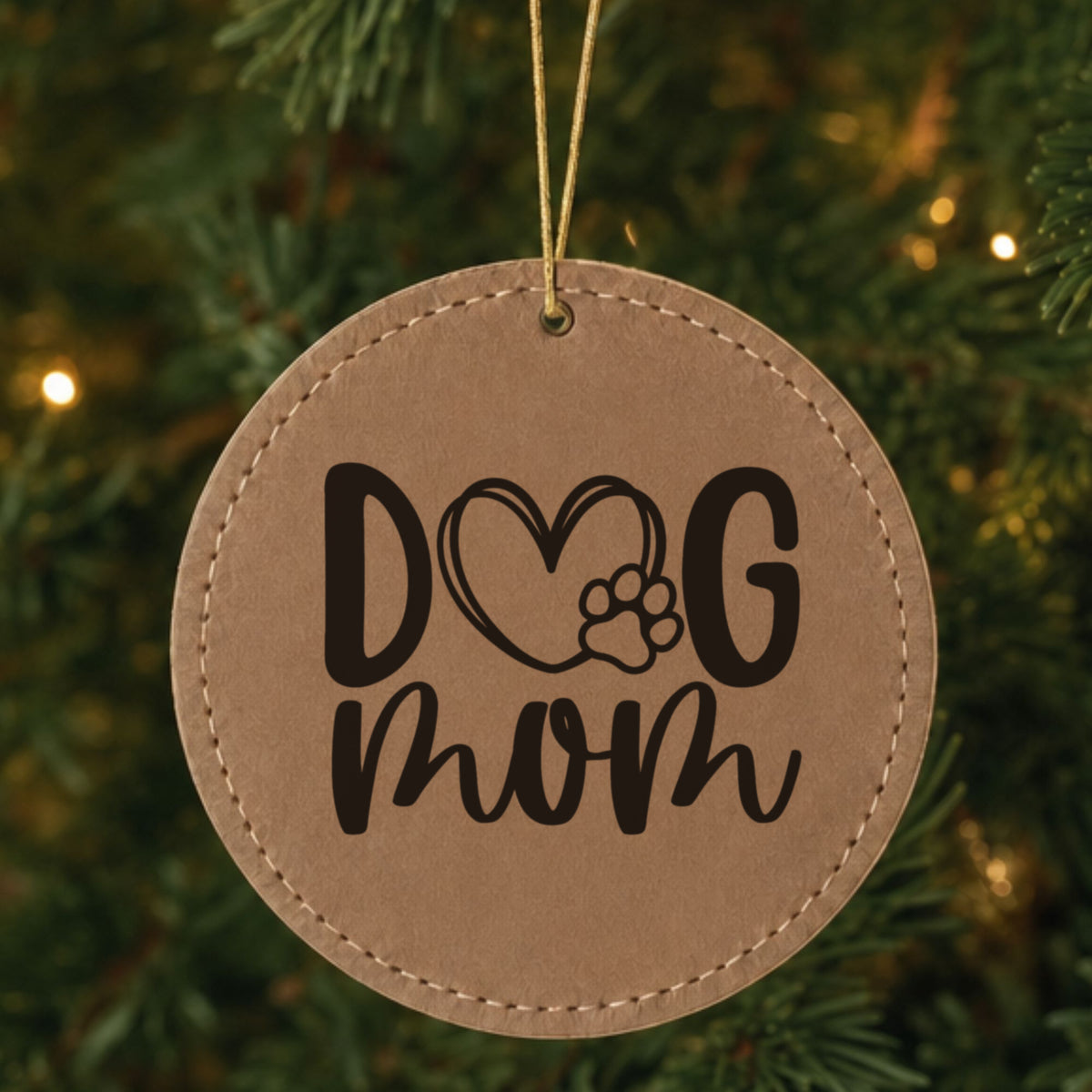 Brown leatherette Christmas ornament engraved with a hand drawn Dog Mom heart and paw design