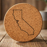 California round cork coaster engraved with a clean state outline