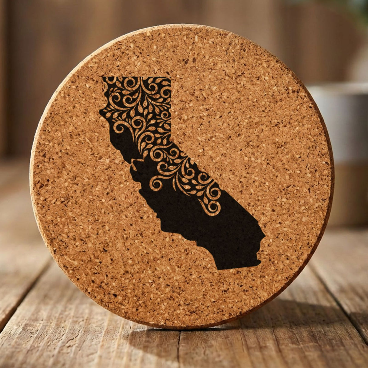 California round cork coaster engraved with the state shape in ornate floral scrollwork