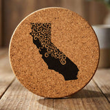 California round cork coaster engraved with the state shape in ornate floral scrollwork