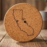California round cork coaster engraved with the state outline and home in script with a heart