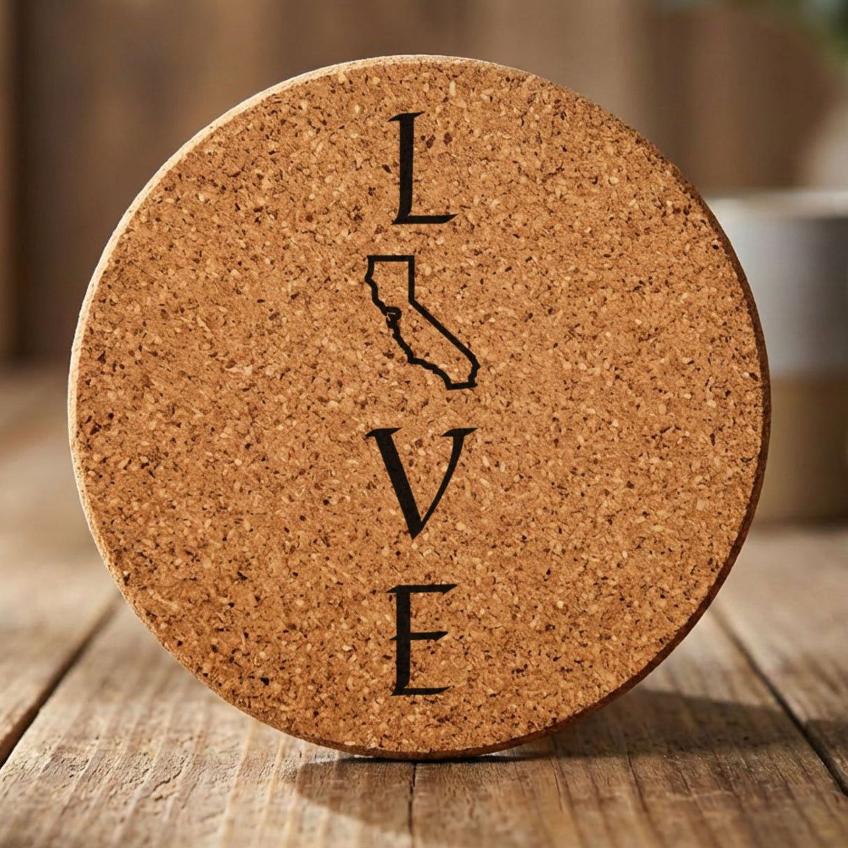 California round cork coaster engraved with LOVE stacked vertically using the state as the letter O