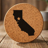 California round cork coaster engraved with the state shape and a star