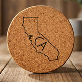 California round cork coaster engraved with the state outline and CA initials