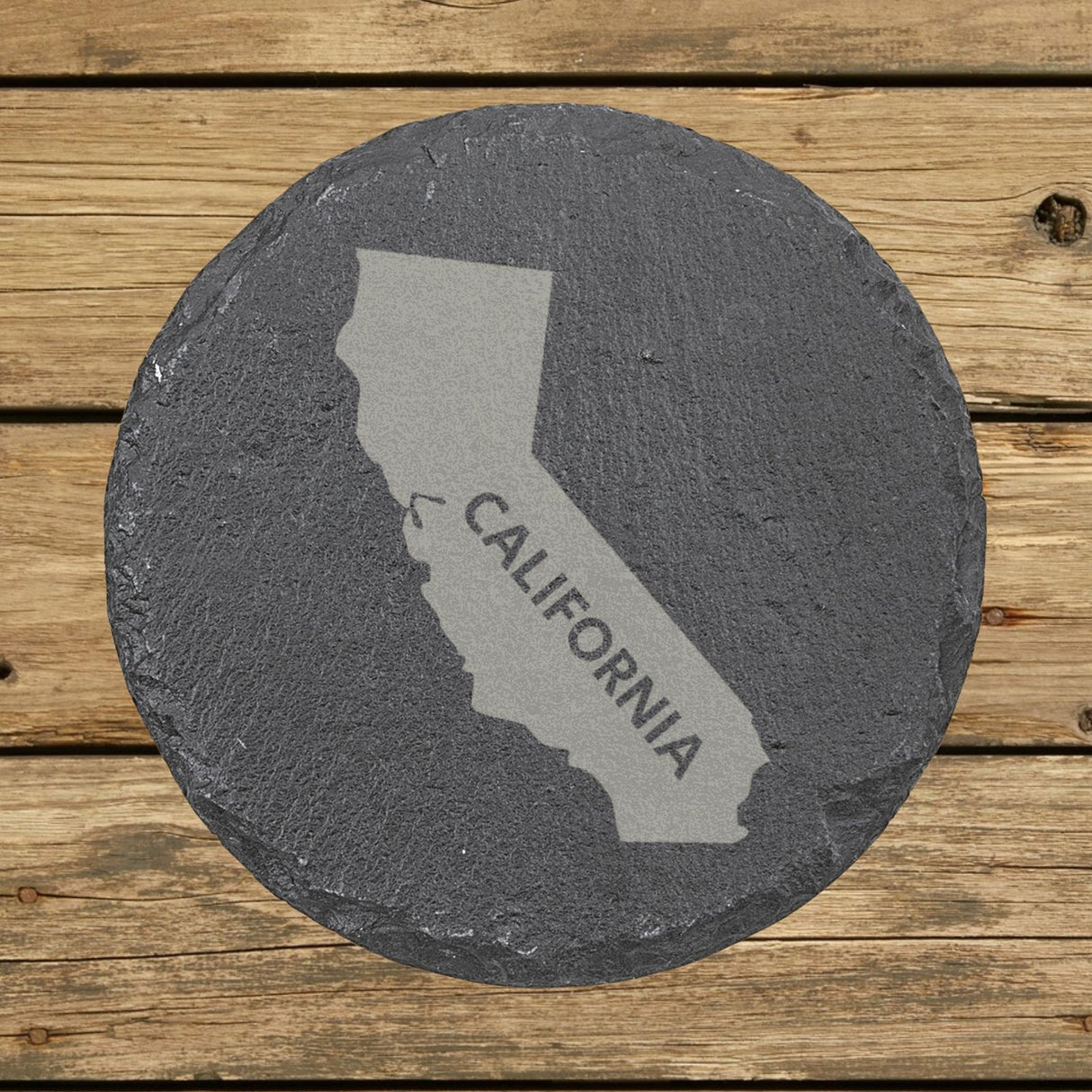 California round slate coaster engraved with the state shape and CALIFORNIA in bold lettering