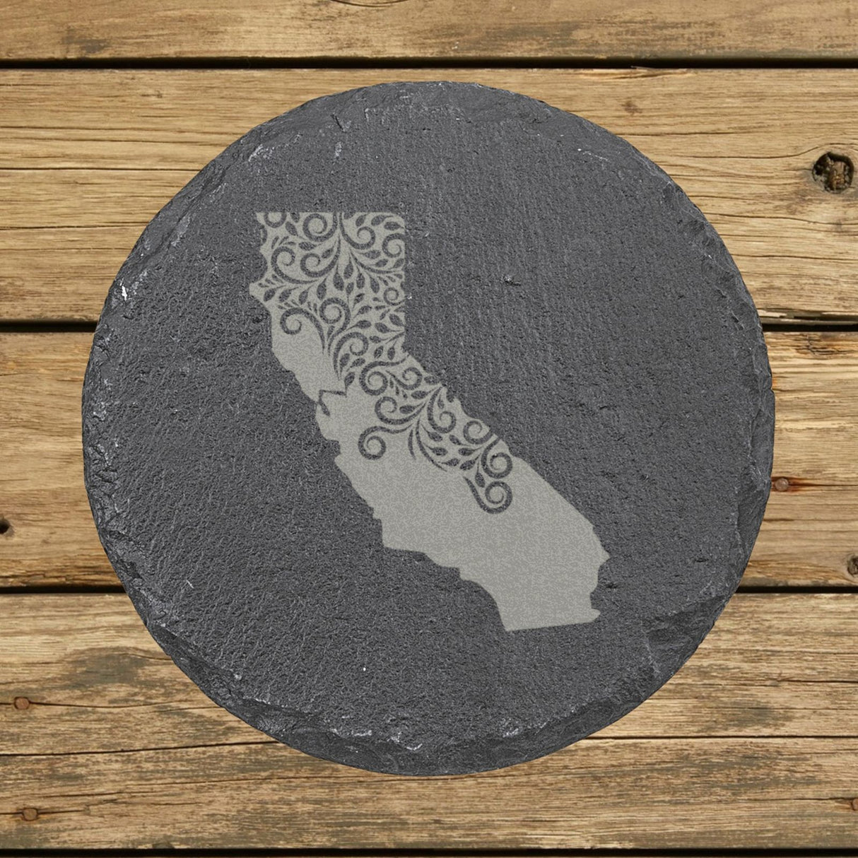 California round slate coaster engraved with the state shape in ornate floral scrollwork
