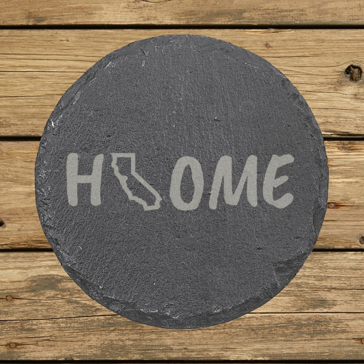 California round slate coaster engraved with HOME using the state outline as the letter O