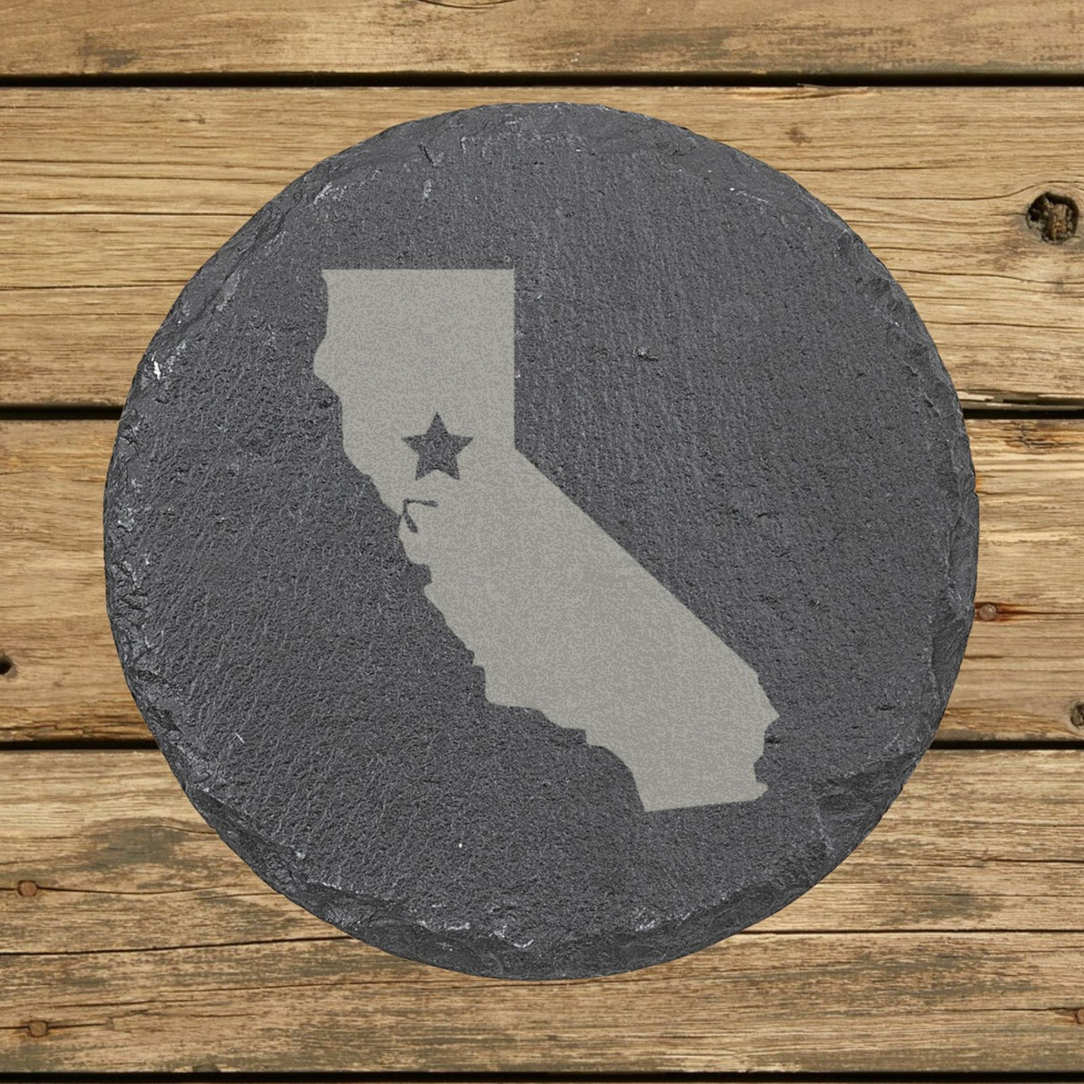 California round slate coaster engraved with the state shape and a star