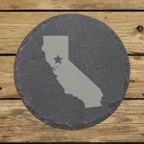 California round slate coaster engraved with the state shape and a star