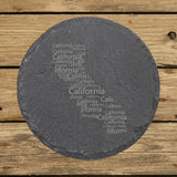 California round slate coaster engraved with a word cloud of repeating California text