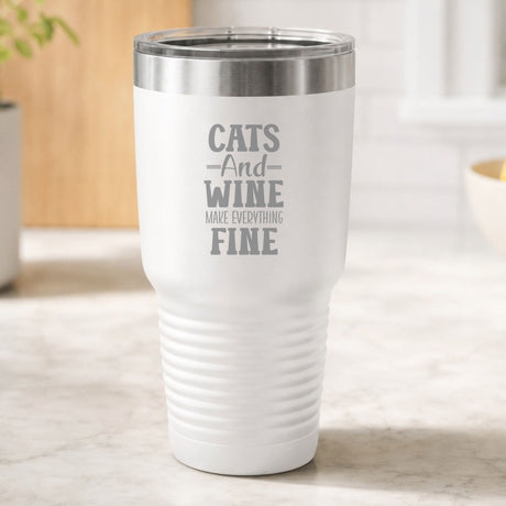 White 30 oz tumbler laser engraved with "Cats and Wine Make Everything Fine", on a kitchen counter