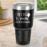 Black 30 oz tumbler laser engraved with "Cheers to Pour Decisions", on a kitchen counter
