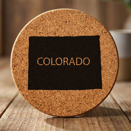 Colorado round cork coaster engraved with the state shape and COLORADO in bold lettering