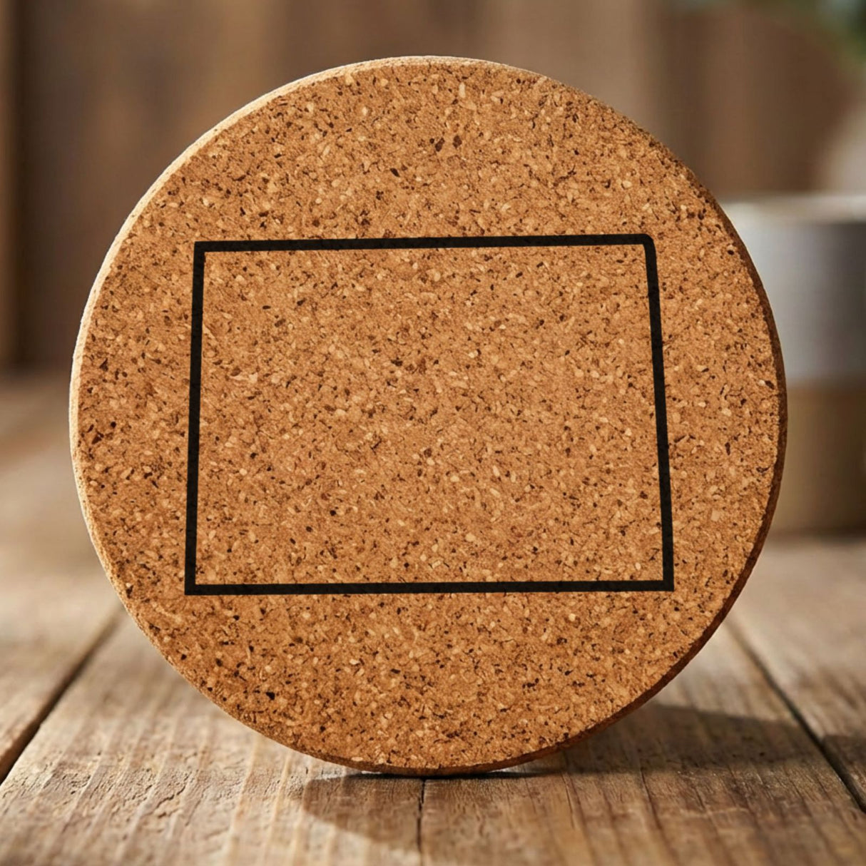 Colorado round cork coaster engraved with a clean state outline