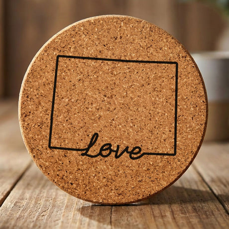 Colorado round cork coaster engraved with a hand-drawn state outline and love in cursive