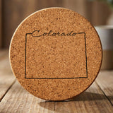 Colorado round cork coaster engraved with the state outline and Colorado in script lettering
