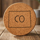 Colorado round cork coaster engraved with the state outline and CO initials