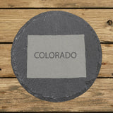 Colorado round slate coaster engraved with the state shape and COLORADO in bold lettering