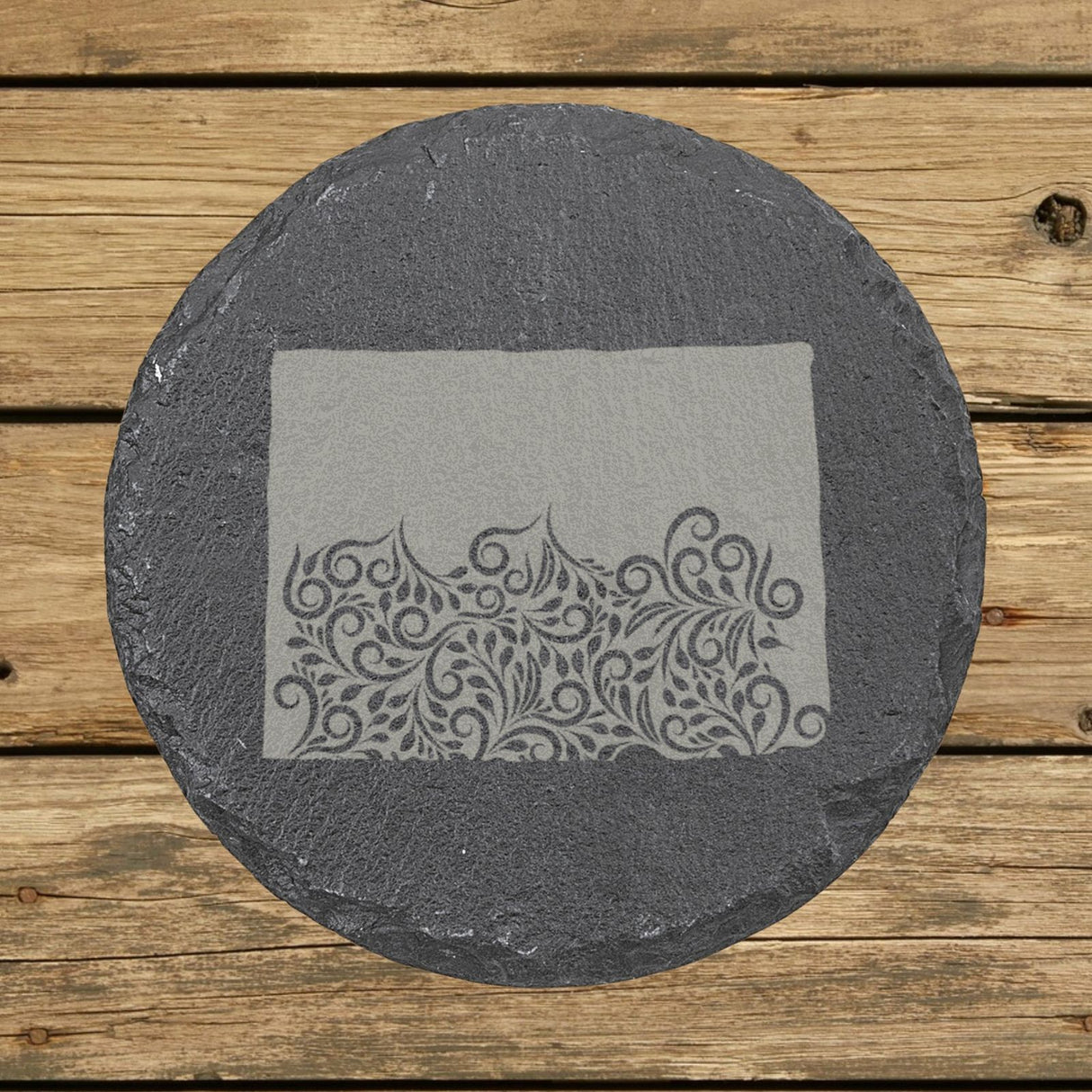 Colorado round slate coaster engraved with the state shape in ornate floral scrollwork