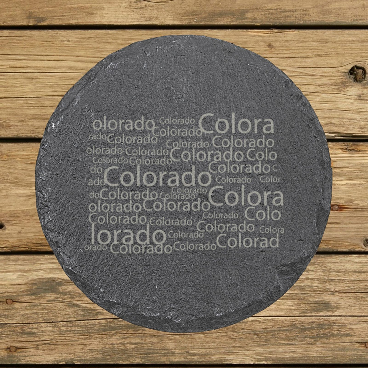 Colorado round slate coaster engraved with a word cloud of repeating Colorado text