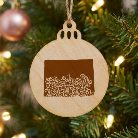 Colorado round wood Christmas ornament engraved with the state shape in ornate floral scrollwork