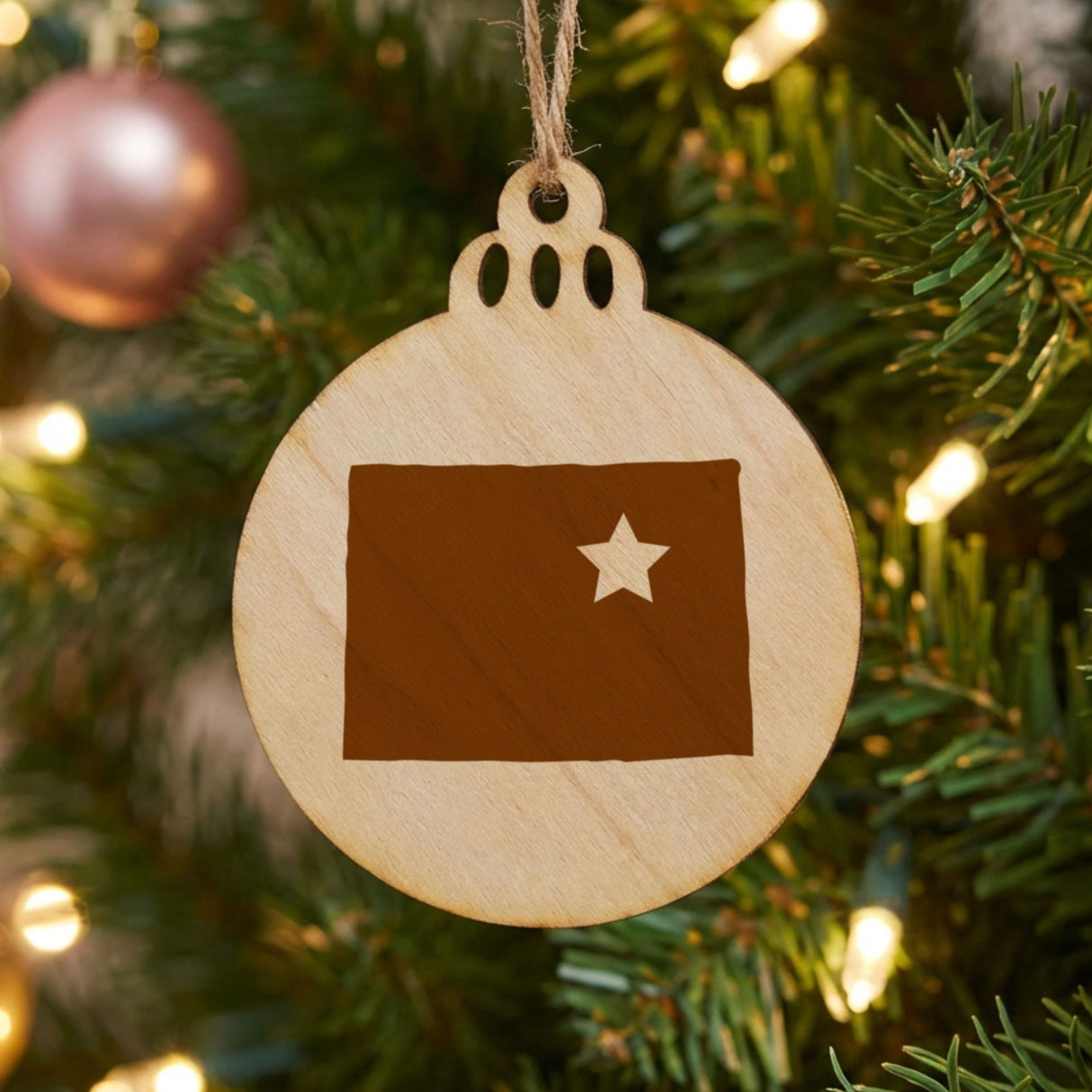 Colorado round wood Christmas ornament engraved with the state shape and a star