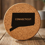 Connecticut round cork coaster engraved with the state shape and CONNECTICUT in bold lettering