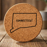 Connecticut round cork coaster engraved with the state outline and CONNECTICUT in hand-drawn brush lettering