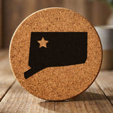 Connecticut round cork coaster engraved with the state shape and a star