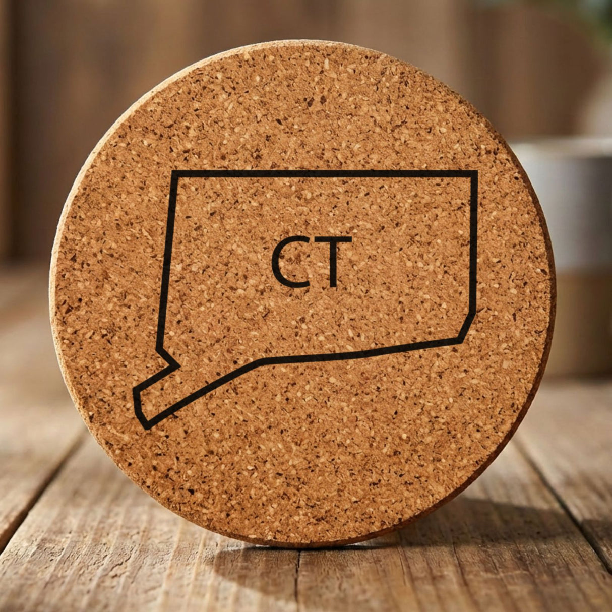 Connecticut round cork coaster engraved with the state outline and CT initials